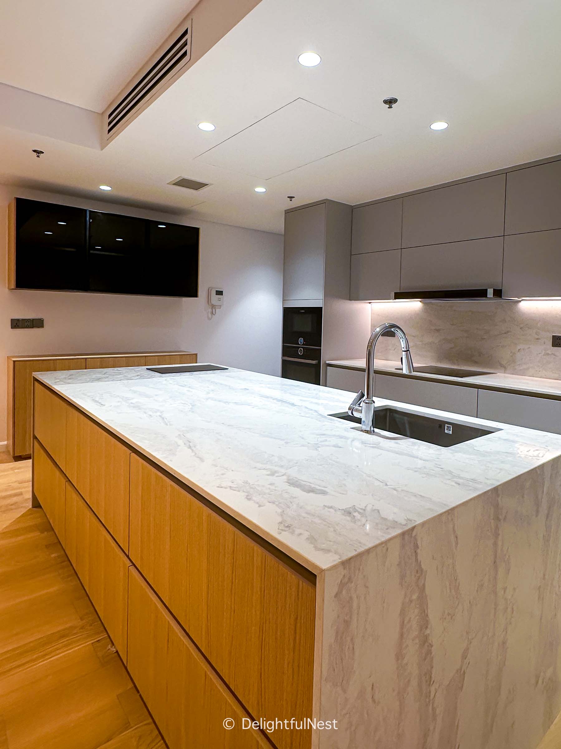 a kitchen island that uses an easy and beautiful solution to hide quartz countertop seams.